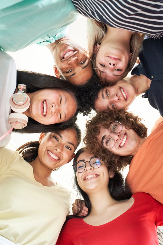 vertical-photo-of-a-multiracial-group-of-friends-taking-a-selfie.jpg